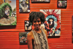 Ashley Lorraine posing in front of her work at her 'Faces of Zulu' Exhibit